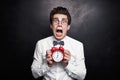 Funny man showing alarm clock and screaming Royalty Free Stock Photo