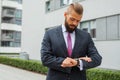 Young nervous bussinessman checking time while waiting for a meeting. Royalty Free Stock Photo