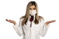 Young nervous female doctor with  face medical mask and questionable gesture Royalty Free Stock Photo