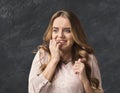 Young nervous woman biting her nails Royalty Free Stock Photo