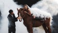 Young newlywed couple, beautiful beauty bride in fashion white bridal wedding costume riding on strong muscular horse standing by Royalty Free Stock Photo