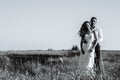 Young newlywed couple walking in field in sunlight outdoor Royalty Free Stock Photo