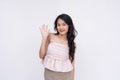 A young nice asian woman saying hello. A warm greeting from a friend. Isolated on a white background Royalty Free Stock Photo