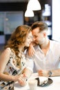 Young nice girl and boy sitting at cafe, drinking coffee and resting. Royalty Free Stock Photo