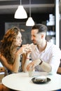 Young nice girl sitting with boyfriend at cafe and resting. Royalty Free Stock Photo