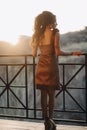 Young nice looking girl enjoying the evening sunlight in street Royalty Free Stock Photo