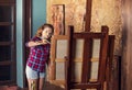 Young nice teenager girl is bending on the molbert inthe art studio Royalty Free Stock Photo