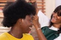 Young Nigerian female having her hair done in a salon Royalty Free Stock Photo