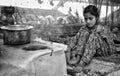 A young nomadic girl preparing food for his parents in a valley famber of district Anantnag kashmir, india