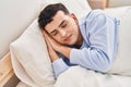 Young non binary man lying on bed sleeping Royalty Free Stock Photo