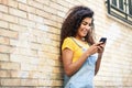 Young North African woman texting with her smart phone outdoors Royalty Free Stock Photo