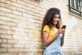 Young North African woman texting with her smart phone outdoors Royalty Free Stock Photo