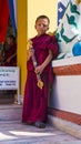 A Young novice monk holds incense burner , Nepal