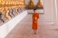 Young novice monk walking for meditation at Wat Phutthai Sawan temple, Ayutthaya, Thailand