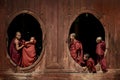 Young novice monks at window wooden Church