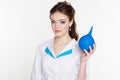 Young nurse with blue enema in hands