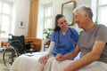 Young nurse checking elderly senior in his home. Royalty Free Stock Photo