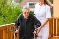 Young nurse and female senior with walking frame Royalty Free Stock Photo
