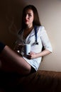 Young nurse girl sitting with coffee cup Royalty Free Stock Photo