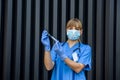 Young nurse holding vials medication and injection needle. Medical doctor picking up medication into syringe