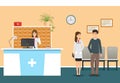 Young nurse at hospital reception desk in clinic and woman doctor in uniform standing with patient. Scene from hospital Royalty Free Stock Photo