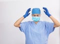 Young nurse in medical blue equipment exclaiming emotion