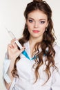 Young nurse with syringe on white background
