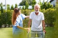 A young nurse walks with an old man in the park. Happy active old man trying to walk with the help of a female doctor Royalty Free Stock Photo