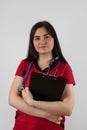 young nurse wearing red uniform with stethoscope hold clipboard isolated on white background Royalty Free Stock Photo