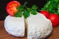 Young oak cheese cutting Board with tomatoes and parsley. Mozarella for pizzas and salads. Royalty Free Stock Photo