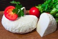 Young oak cheese cutting Board with tomatoes and parsley. Mozarella for pizzas and salads. Royalty Free Stock Photo