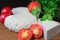 Young oak cheese cutting Board with tomatoes and parsley. Mozarella for pizzas and salads. Royalty Free Stock Photo