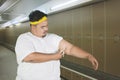 Young obese man measuring fat layer of his arm Royalty Free Stock Photo