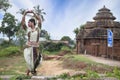 Young odissi dancer striking pose in front of Sukasari temple with sculptures in bhubaneswar, odisha, India. Indian Culture