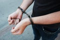 Young offender in handcuffs on wrists Royalty Free Stock Photo