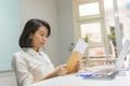 Young office woman reading financial document Royalty Free Stock Photo