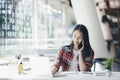 Young office woman talking on mobile phone with client