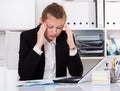 Young office worker woman in black suit is having complicated issue with project Royalty Free Stock Photo