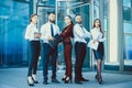 Young office workers on the background of a multi-storey glass b