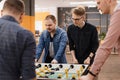 Young Office Workers Playing Table Soccer Royalty Free Stock Photo