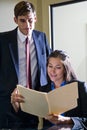 Young office workers reviewing folder Royalty Free Stock Photo