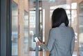 Young officer woman holding a key card to lock and unlock door for access entry. Door access control. Back view Royalty Free Stock Photo