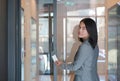 Young officer woman holding a key card to lock and unlock door for access entry. Door access control