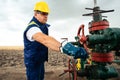 Oil worker is turning valve on the oil pipeline. Oil and Gas Industry. Royalty Free Stock Photo