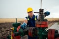 Oil worker is turning valve on the oil pipeline. Oil and Gas Industry. Royalty Free Stock Photo