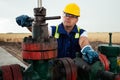 Oil worker is turning valve on the oil pipeline. Oil and Gas Industry. Royalty Free Stock Photo