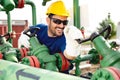 Oil worker turning valve on oil rig Royalty Free Stock Photo