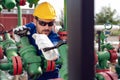 Oil worker turning valve on oil rig Royalty Free Stock Photo