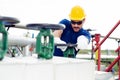 Oil worker turning valve on oil rig Royalty Free Stock Photo