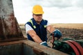 Oil worker is turning valve on the oil pipeline. Oil and Gas Industry. Royalty Free Stock Photo